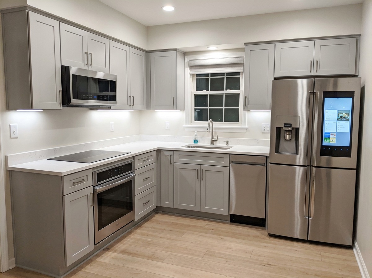 Bright modern smart kitchen with flat-panel cabinetry and quartz counters after modernization